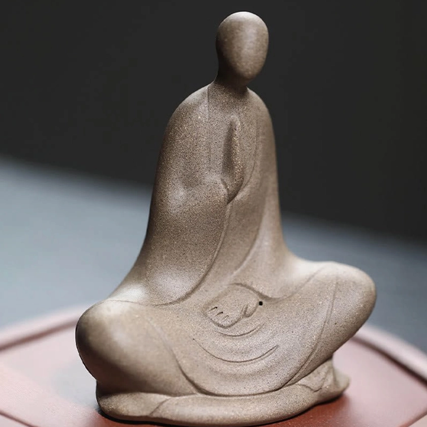 Faceless Buddhist meditation statue ceramic - three-quarter side perspective with prayer hands detail