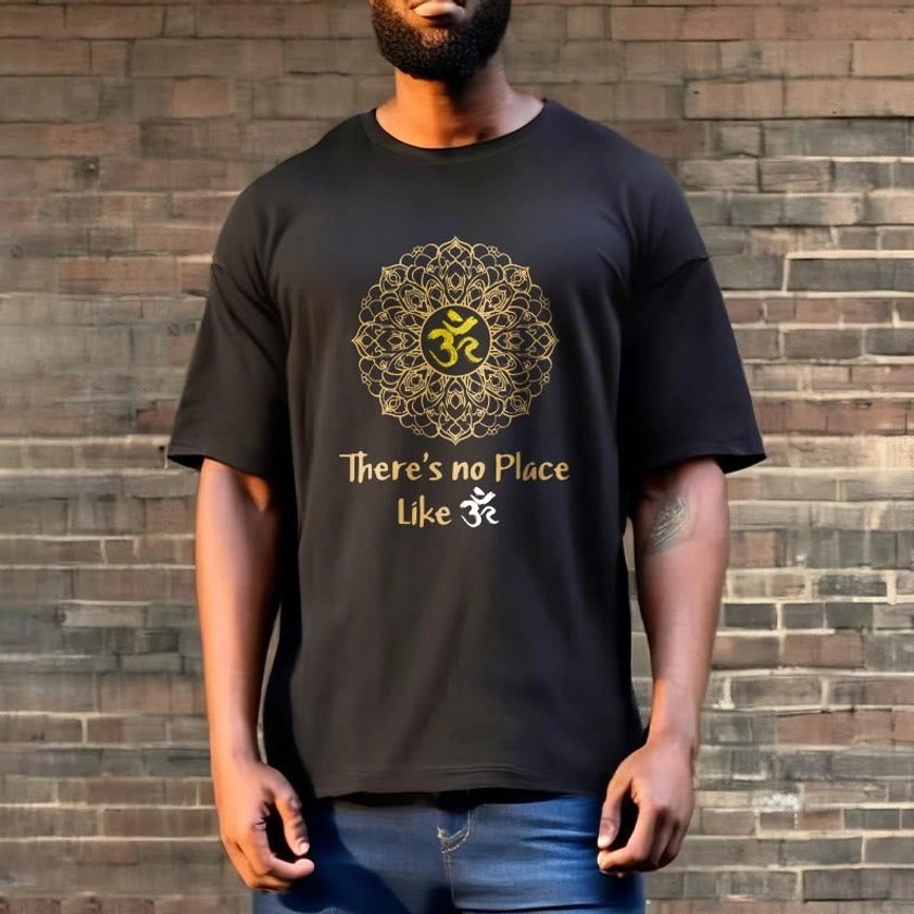 Faded black Om mandala t-shirt worn by male model against brick wall, relaxed fit daily wear