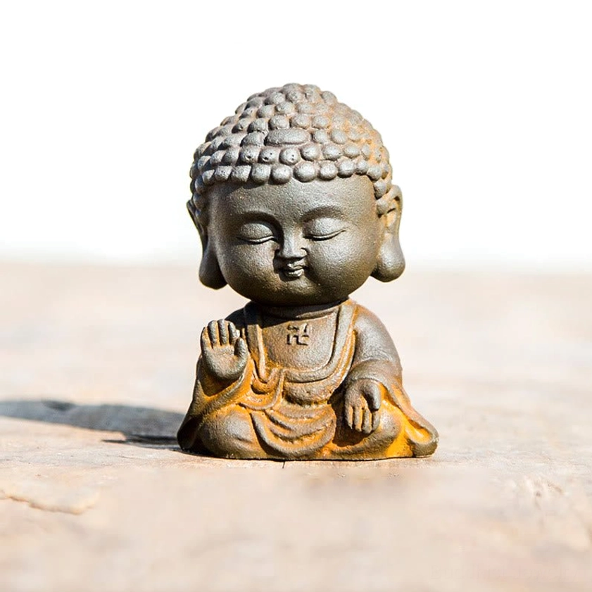 Fearless Buddha statue in abhaya mudra pose with raised hand blessing gesture for protection and courage
