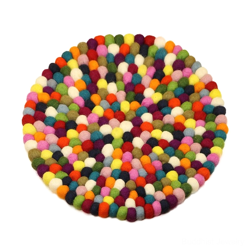 Neatly arranged colorful felted wool pom-poms showing soft texture and vibrant color palette