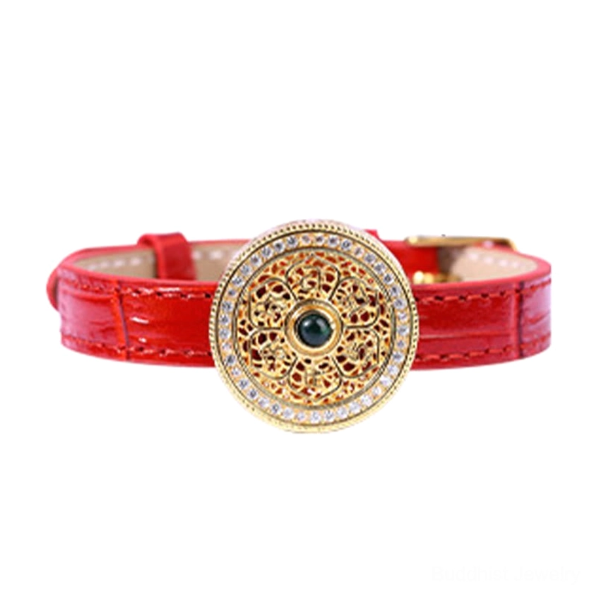Detailed front view of handcrafted Eight Treasures Compass charm with intricate filigree pattern, red leather strap, and dark green jade gem