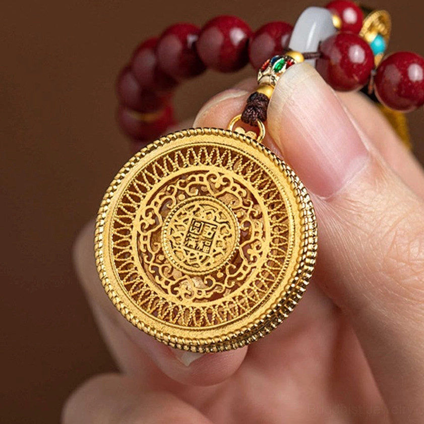 Detailed view of carved gold filigree pendant with central blessing pattern, authentic Buddhist spiritual ornament craftsmanship