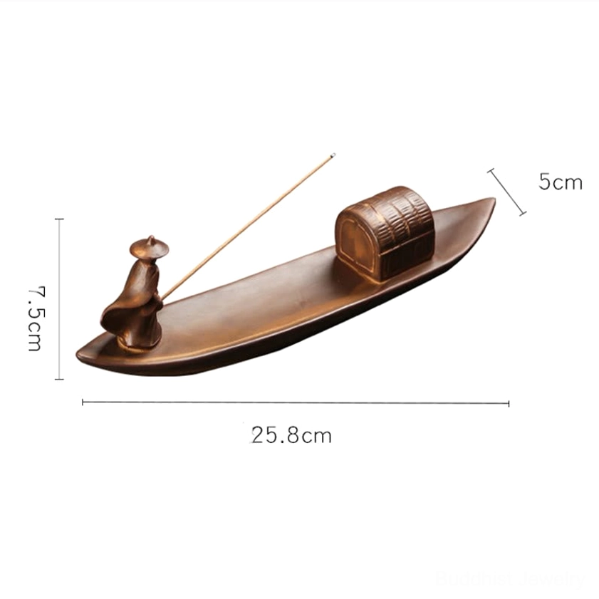 Fisherman figurine holding incense stick in hand, close-up showing incense slot design