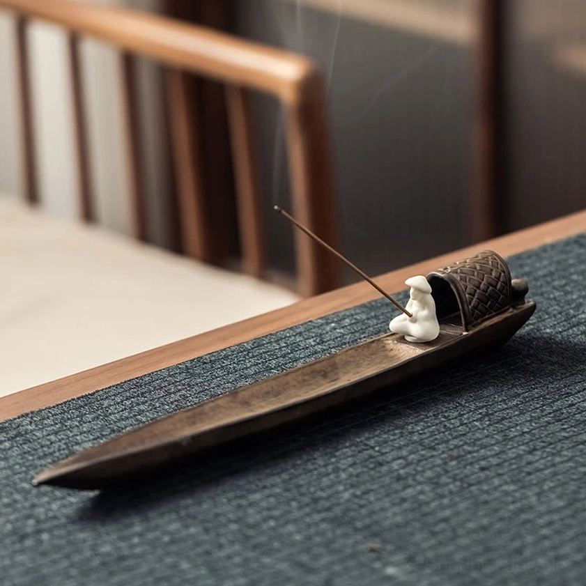 Overhead perspective of Buddhist incense holder showing woven cabin details and incense stick placement