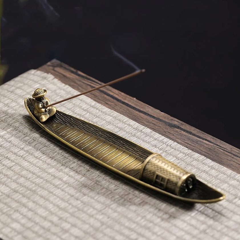 Fishing boat incense holder high angle view with smoke and woven texture details