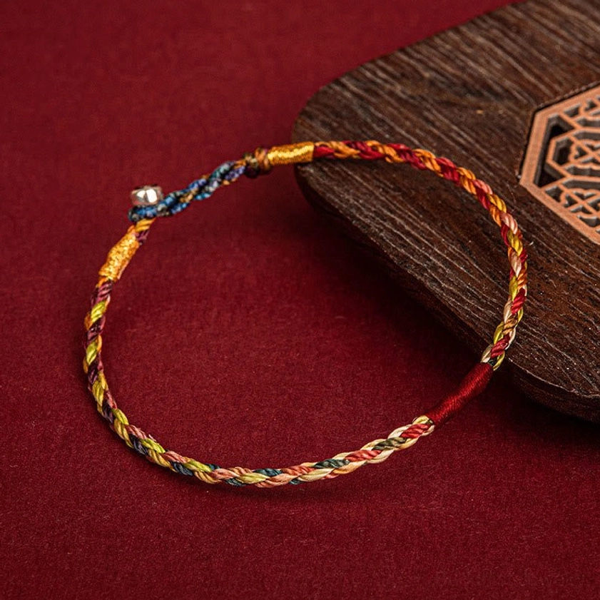 Multi-colored Buddhist lucky bracelet with magnetic metal clasp shown in side perspective view