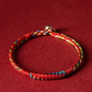 Five-color Buddhist protection bracelet with red braided cord and multi-color thread details, handmade blessed string bracelet front view