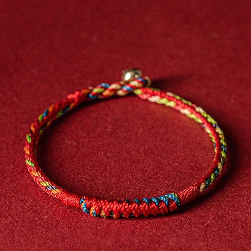 Five-color Buddhist protection bracelet with red braided cord and multi-color thread details, handmade blessed string bracelet front view