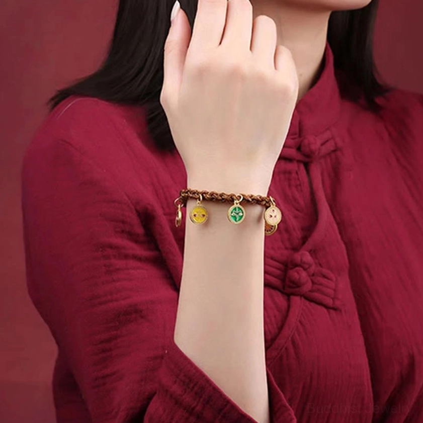 Buddhist wealth deities bracelet front view on wrist with three enamel prosperity charms visible