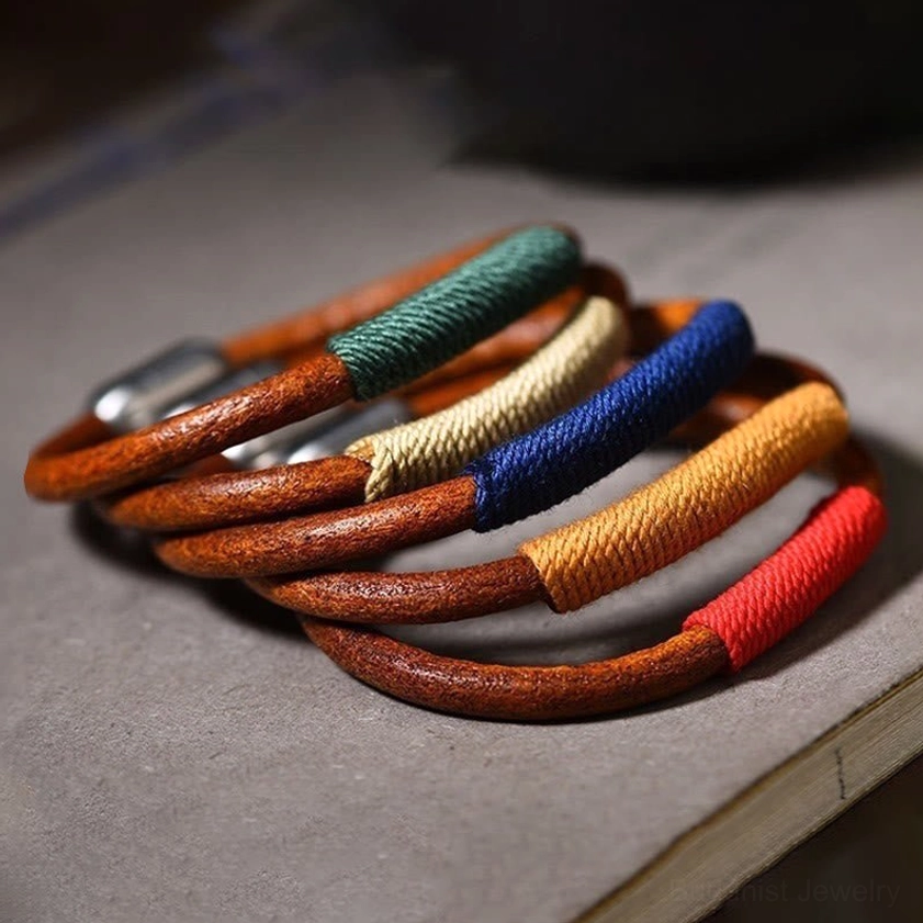 Complete set of five elements leather bracelets stacked showing all color variants blue water red fire yellow earth green wood beige metal
