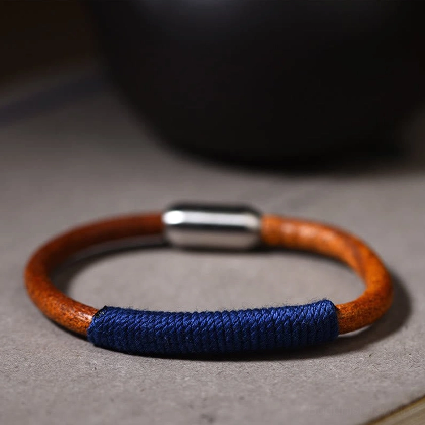 Blue water five elements leather bracelet flat lay showing dark blue woven section and titanium steel buckle