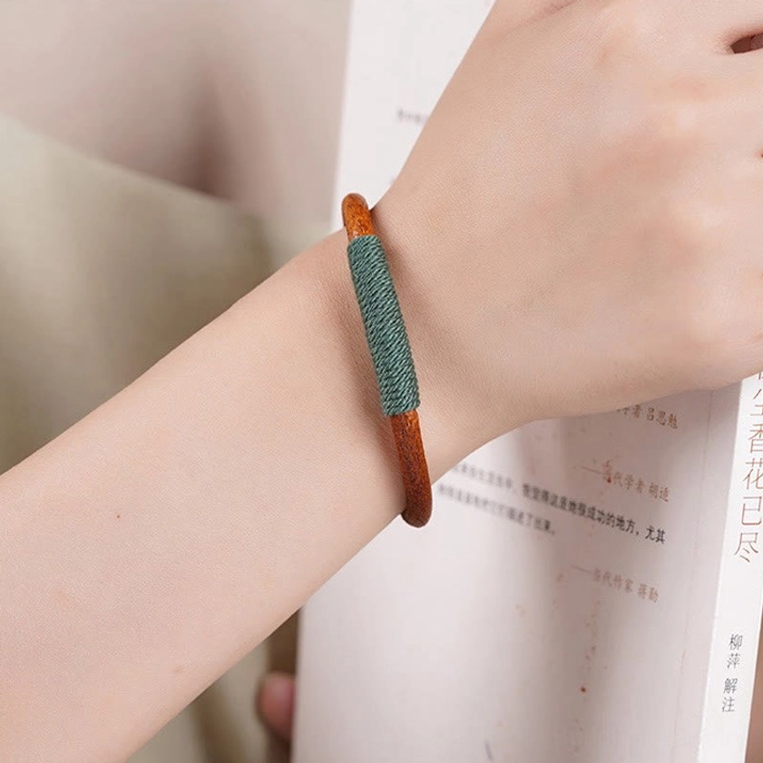 Five elements leather bracelet side view on wrist demonstrating comfortable fit and dark green woven detail