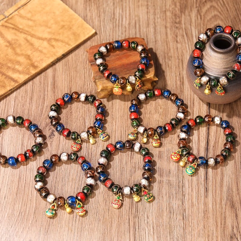 Five Elements Liuli glass bead bracelet on wrist model – showing fit and comfort of elastic premium string with gold charm accents