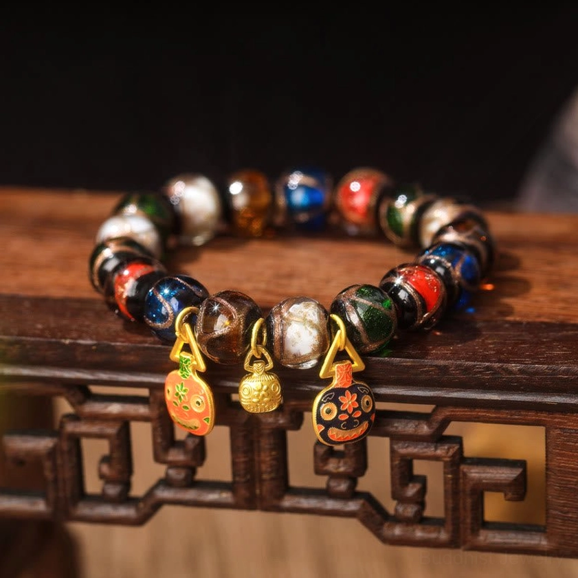 Five Elements Liuli glass bead bracelet with light yellow and dark red patterned enamel pendants – flat red green gold swallowing beast family