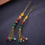 Five Gods of Wealth agate hanging charm flat lay showing two matching pairs with mixed colored agate beads and colorful braided tassels
