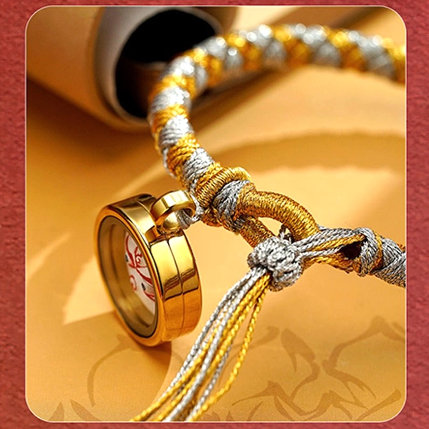 Close-up macro detail of handmade Buddhist bracelet showing braided rope texture, metal-framed Five Gods of Wealth charm, knotted closure, and tassel
