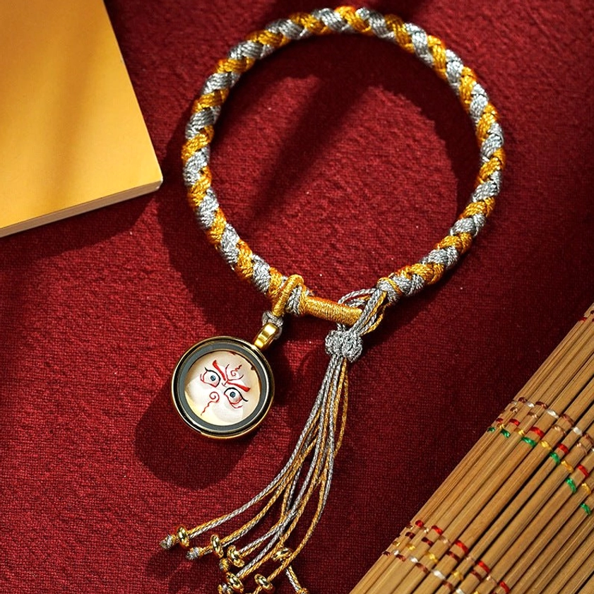 Handmade Buddhist Five Gods of Wealth braided bracelet with gold-silver mixed braid, white round charm amulet, and decorative tassel
