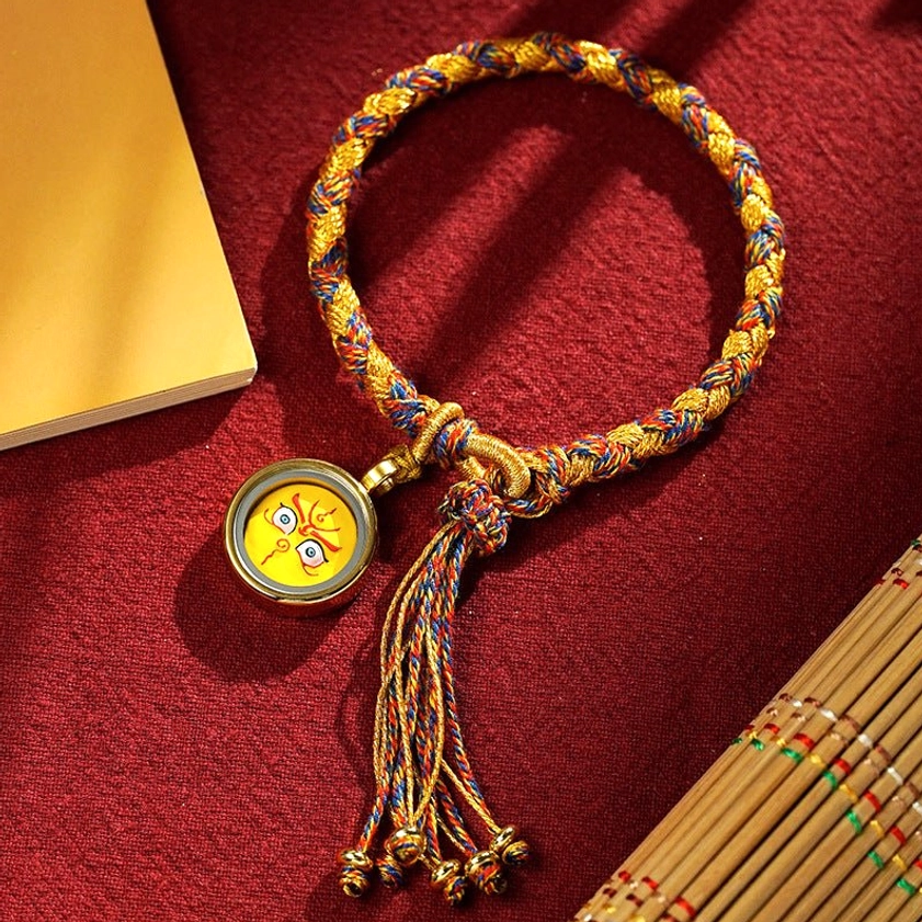 Five Gods of Wealth braided rope bracelet with yellow charm, gold-mixed braid and tassel details, handmade Buddhist prosperity bracelet