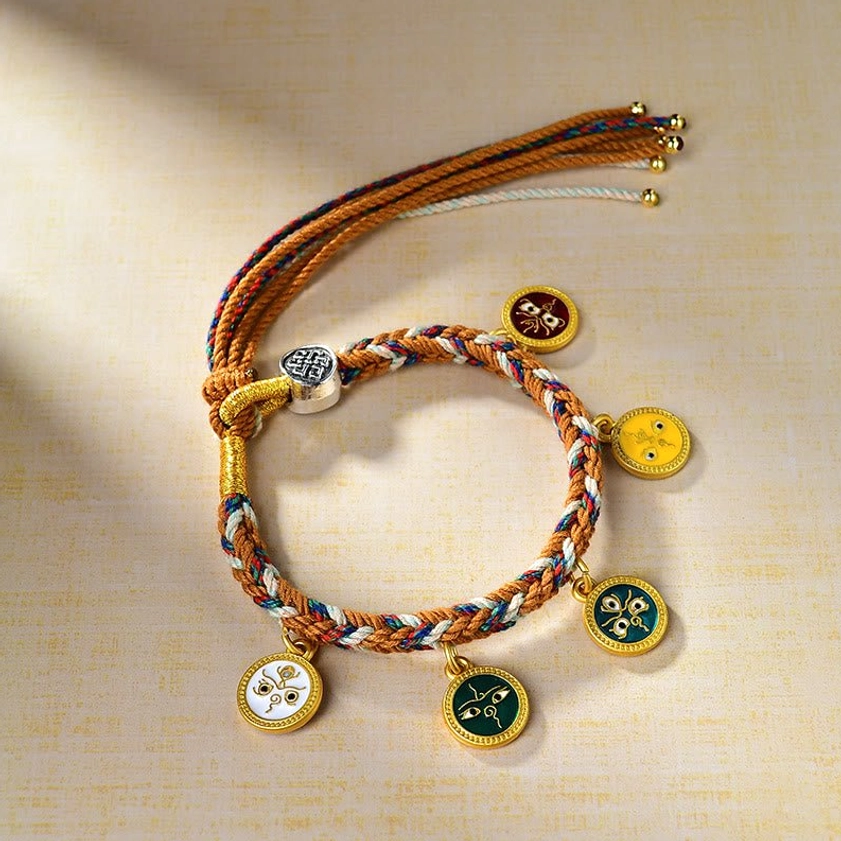 Five Gods of Wealth Buddhist multicolor string bracelet with five enamel charms displayed on beige background, showing intricate braided rope and metal tassel details