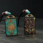 Five Gods of Wealth thangka Buddhist necklace pendant - flat lay with two designs on dark wood table