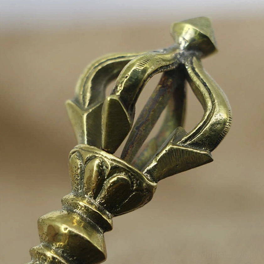 Close-up top view of five prong vajra crown structure showing intricate details and polished brass construction