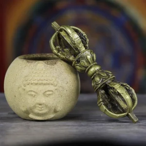 Handmade five-prong copper vajra dorje with dragon motifs, displayed on Buddhist altar with ceramic vessel
