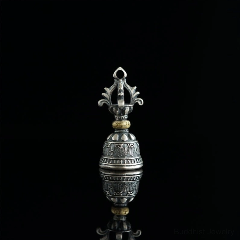 Front upright view of five-pronged dorje vajra bell pendant with engraved sacred texts on pure black background