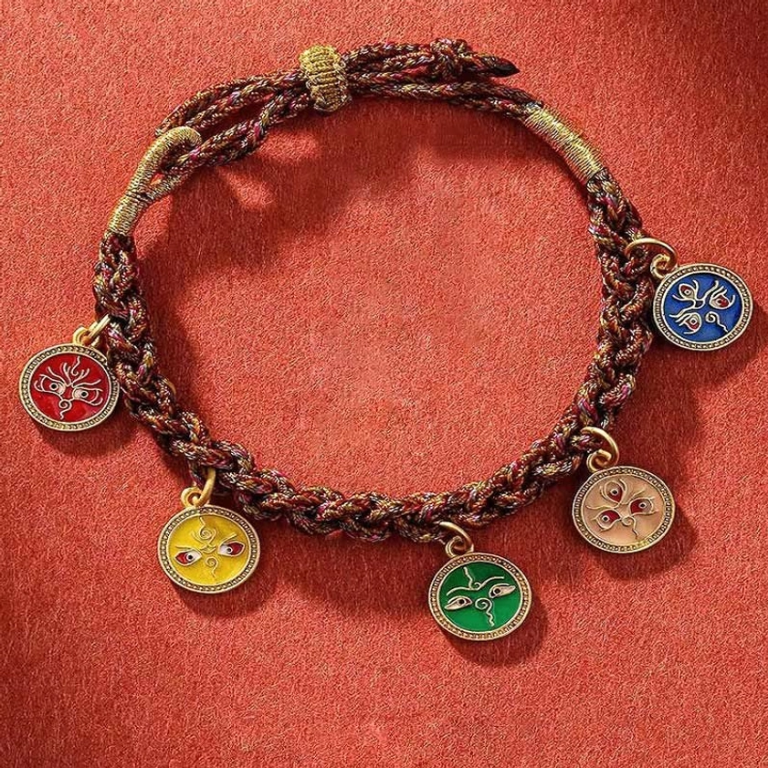 Five wealth deities braided string bracelet with multicolor enamel pendants on red fabric background - Buddhist prosperity charm