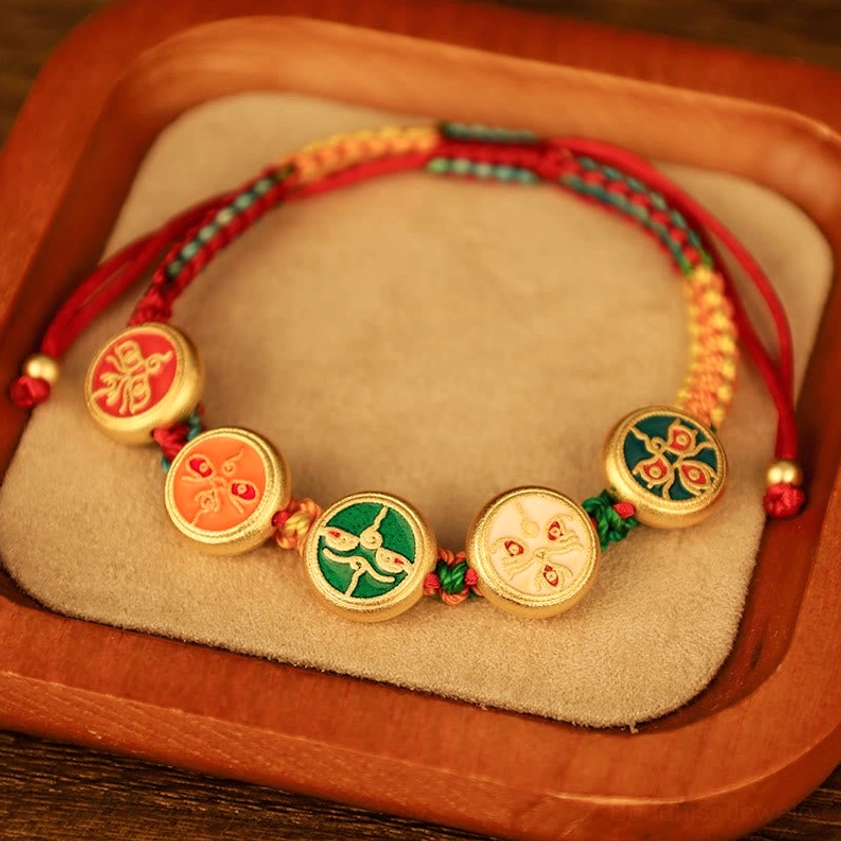 Red-dominant five wealth deities bracelet with gold-framed enamel pendants on wooden jewelry display