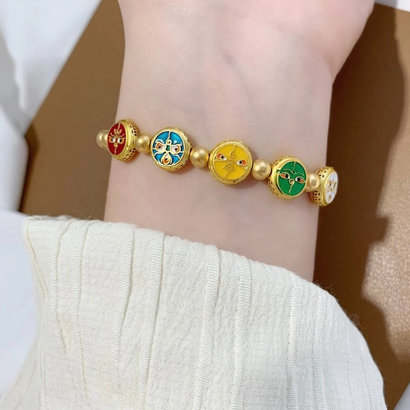 Close-up wrist view of five wealth gods Buddhist bracelet displaying complete set of five enamel fortune charms