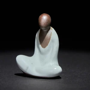 Formless Buddha meditating ceramic statue front view with two-tone brown and cyan glaze finish
