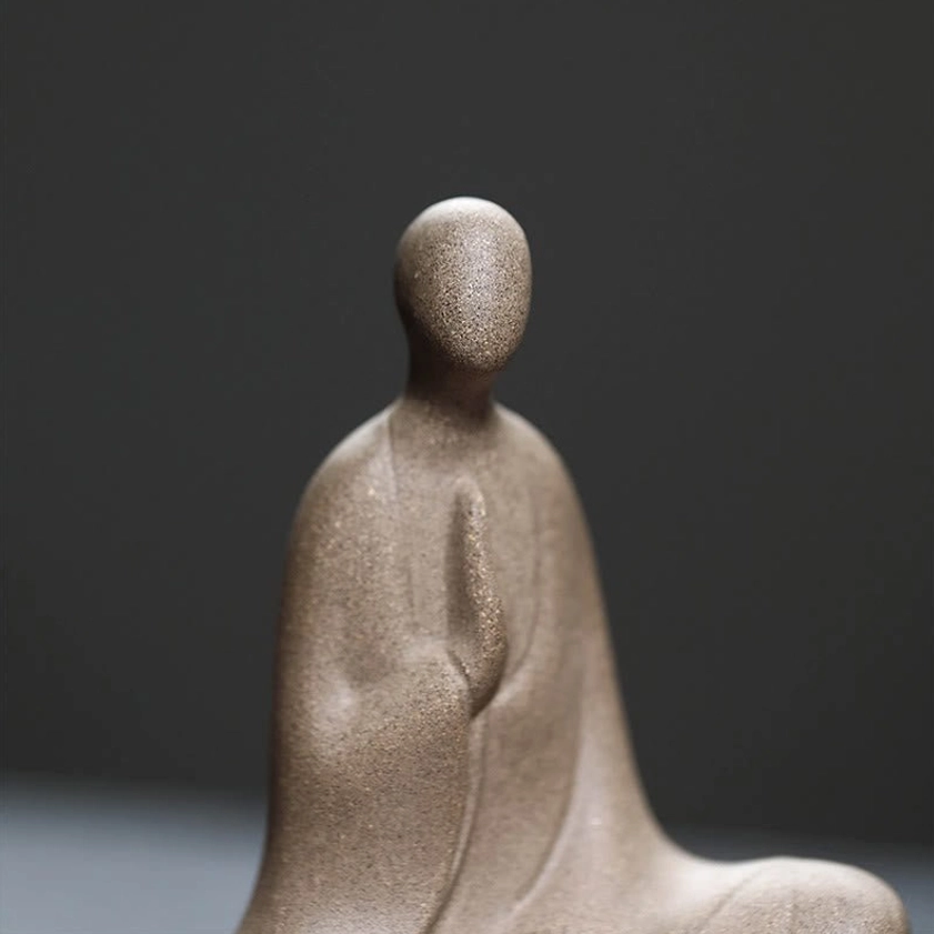 Formless Buddhist statue ceramic - left side angle showing seated prayer hands and serene posture