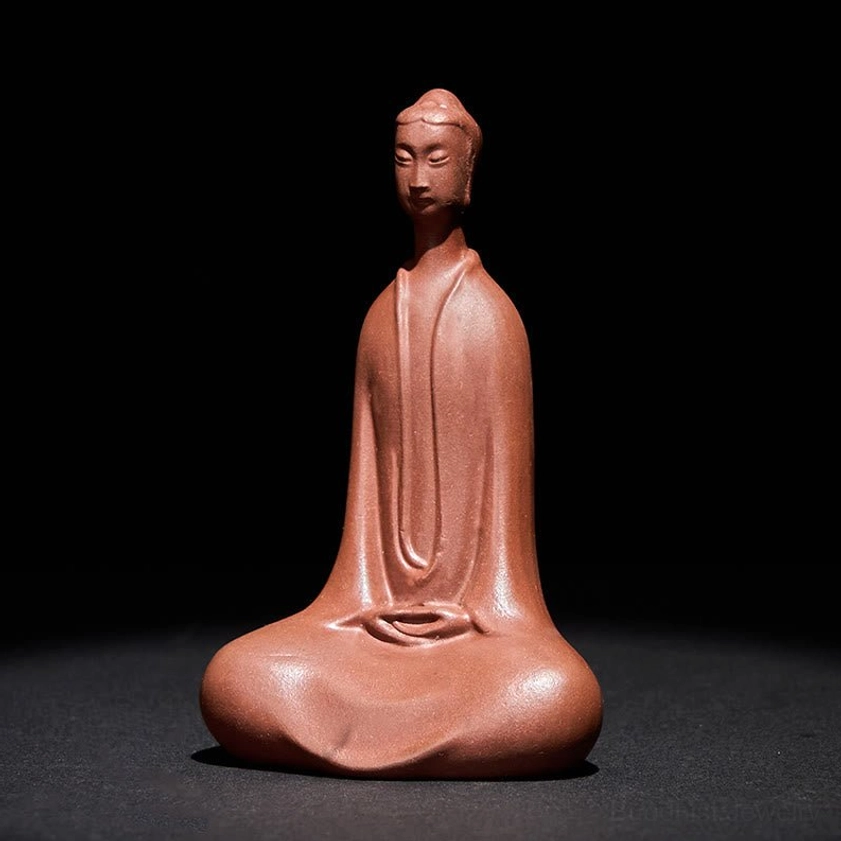 Formless Buddha clay figurine left frontal view showing serene facial expression