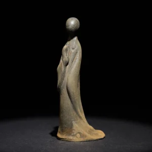 Minimalist standing Buddha statue with praying hands, side view showing weathered iron powder resin finish and flowing monastic robe