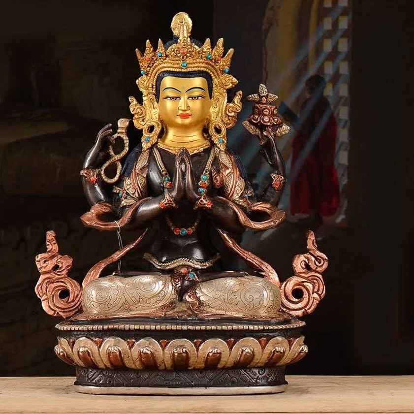 Four-armed Avalokitesvara copper statue with gilded face and turquoise inlay beads, front view on wooden table with natural light