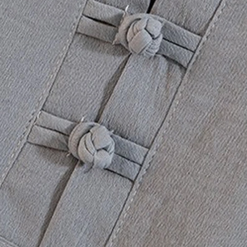 Traditional frog button placket on Buddhist-inspired meditation clothing, showcasing authentic Asian garment closure technique and neat seaming