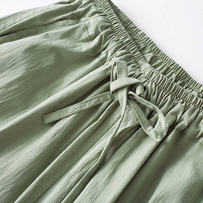 Detail view of traditional Chinese frog button closure on men's Buddhist meditation shirt with stand collar and three-quarter sleeves