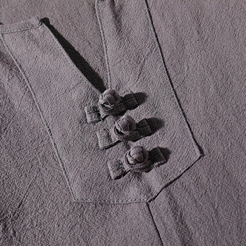 Three frog buttons on meditation top placket - traditional design element close-up
