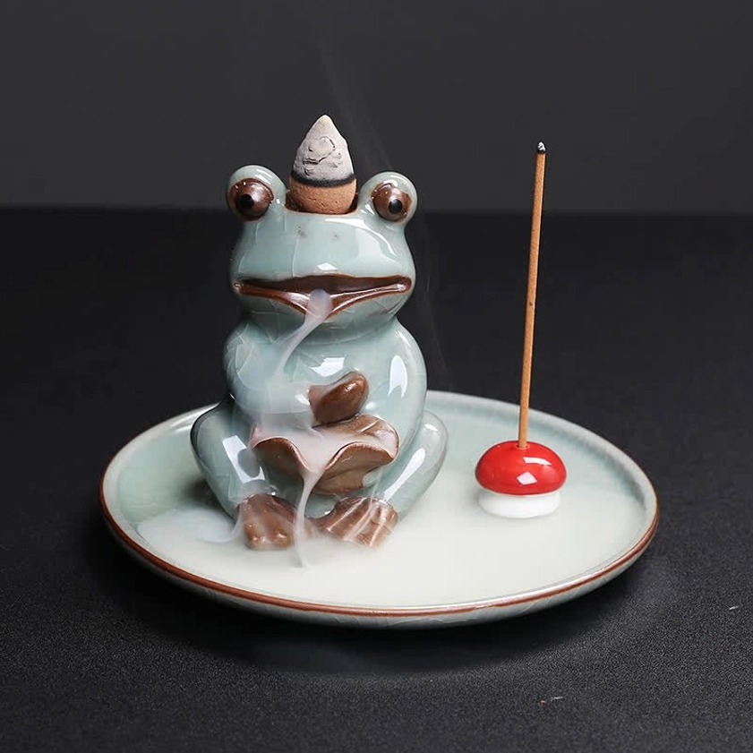 Single frog incense burner on ceramic tray with red mushroom stick holder and incense, overhead perspective showing burner opening