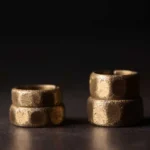 Two frosted copper brass adjustable wealth rings in different widths displayed front view showing hammered matte texture
