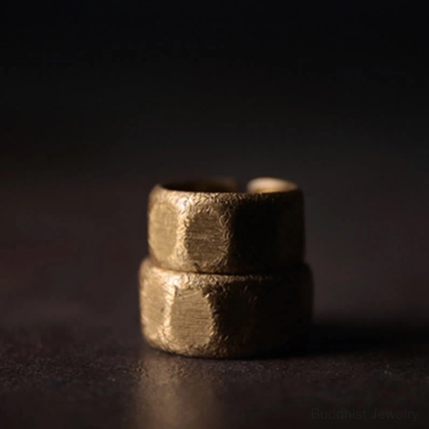 Frosted copper brass wealth ring top-down close-up view showing prominent hammered texture and open cuff band