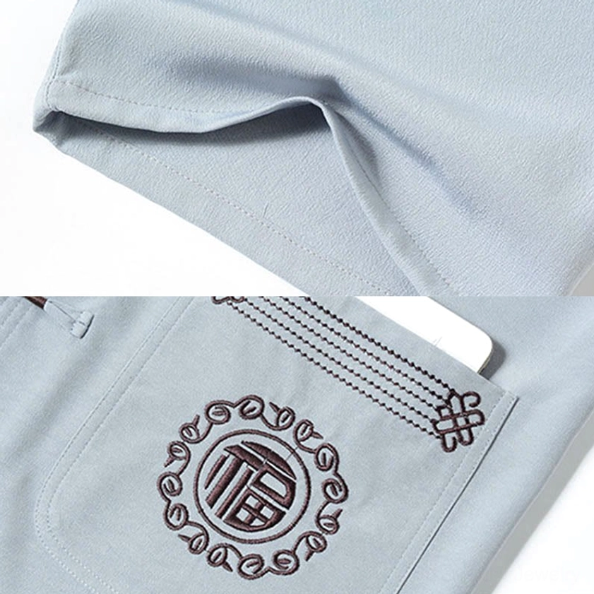 Fu character embroidery close-up detail on Tang suit pocket showing traditional stitching and prosperity symbolism