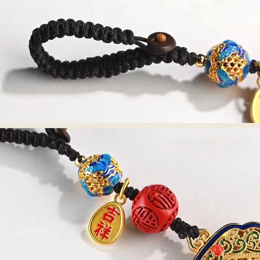 Fu keychain component details showing braided cord cloisonné enamel bead carved red bead and metal auspicious tag