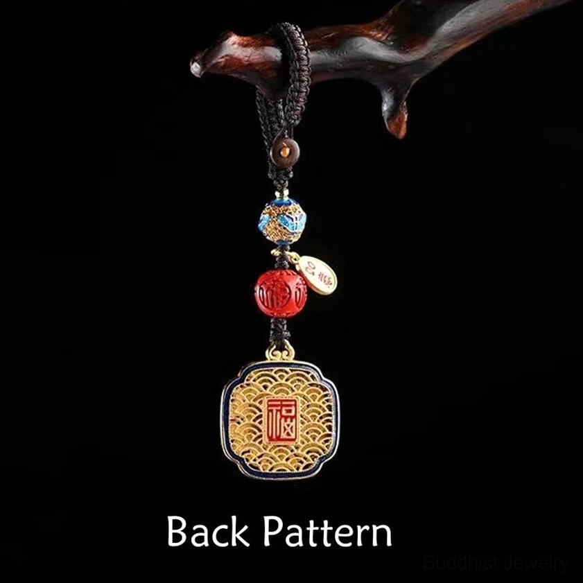 Fu character blessing keychain showing pendant back pattern with enamel and red cinnabar-style beads on black background