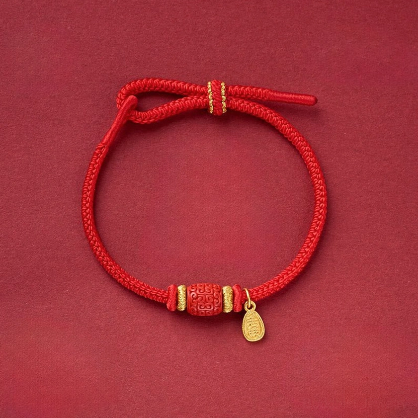 Sacred Fu charm and Om Mani Padme Hum copper red string bracelet close-up flat lay
