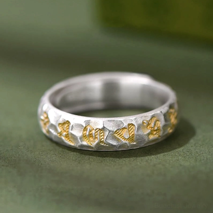 Full wrap-around Om Mani Padme Hum ring front oblique view showing complete Sanskrit mantra and adjustable fit