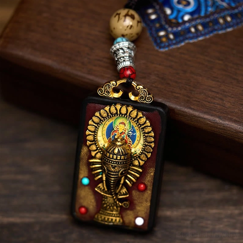 Hand-carved Ganesha wooden pendant with turquoise gemstone and metal bead embellishments