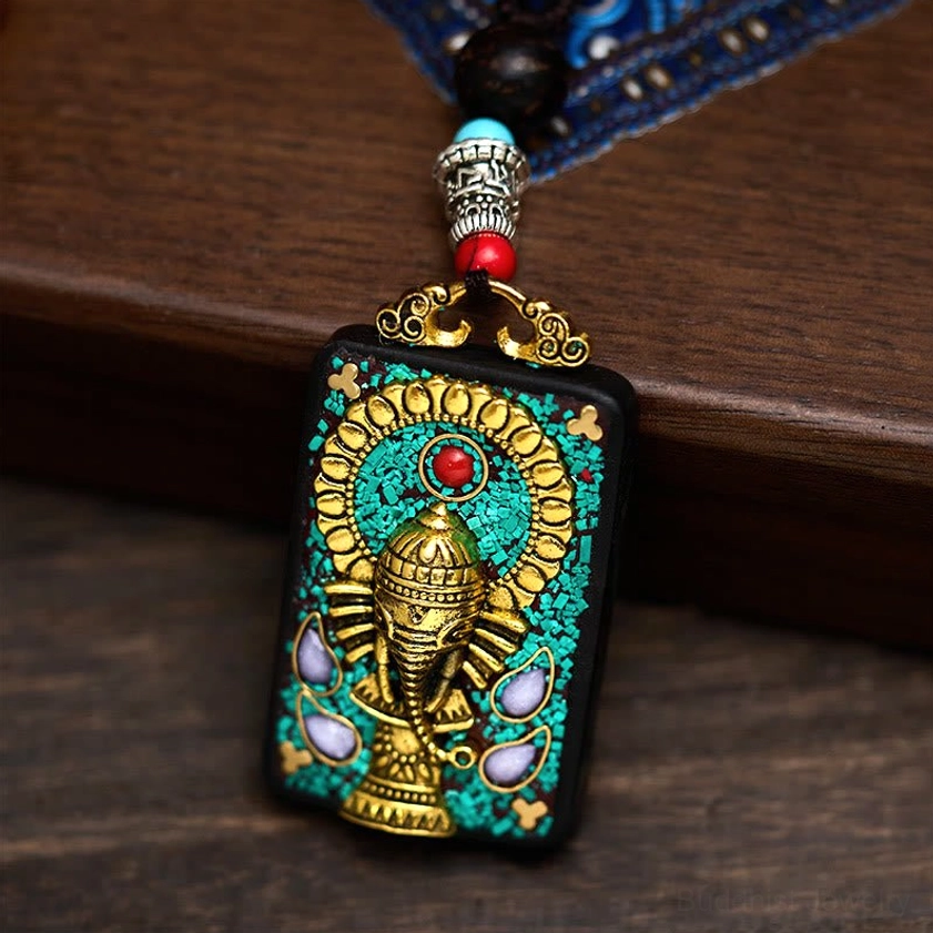 Right side close-up of Ganesha pendant with silver metal fittings and red blue decorative beads