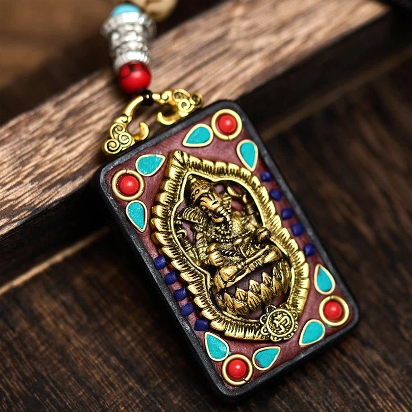 Style D variant of Ganesha wooden pendant with distinctive carving and turquoise accent