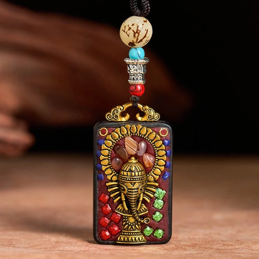 Ganesha pendant with protective spiritual energy representation in ebony wood craft